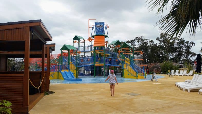 Gumbya World is one of the best things to do in Gippsland with kids. Child running to the water slide