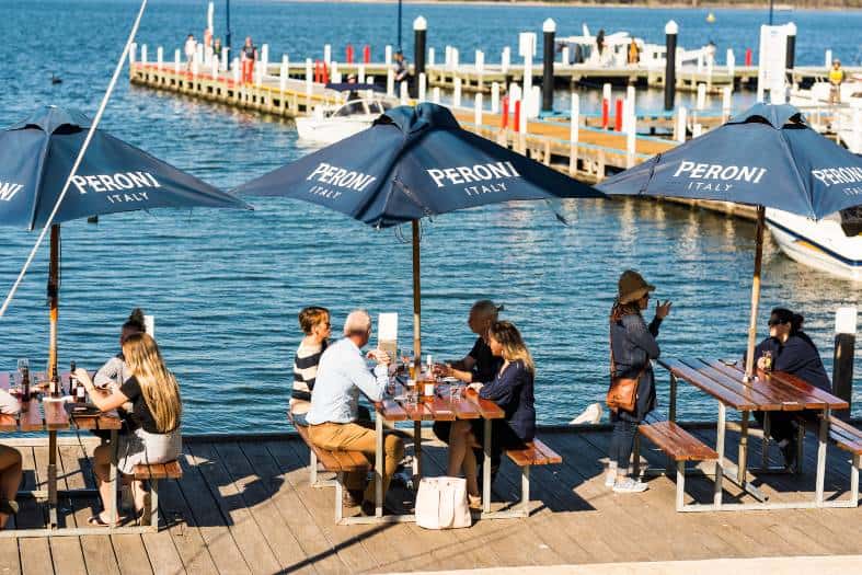 people enjoying food on the jetty at the Metung Pub